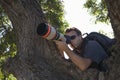 Paparazzi Photographer Against Tree