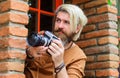 Paparazzi take picture with photocamera. Bearded Journalist with photo camera. Mass media. Detective. Royalty Free Stock Photo