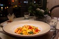 Papardelle pasta with salmon, cream sauce and salmon caviar is on a plate