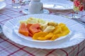 Papaya, banana, mango, pineapple, and orange in a plate on the table. Royalty Free Stock Photo