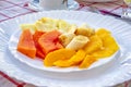 Papaya, banana, mango, pineapple, and orange in a plate. Royalty Free Stock Photo