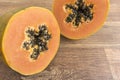 Papaya cut in half in close up on wooden background