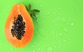 Papaya fruit on bright green background with water drops, fresh exotic fruits border design Royalty Free Stock Photo