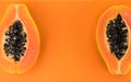 Papaya fruit on orange, yellow background. Half of fresh organic Papaya exotic fruit close up