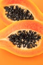 Papaya fruit on orange, yellow background. Half of fresh organic Papaya exotic fruit close up