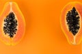 Papaya fruits on orange, yellow background. Halved fresh organic Papaya exotic fruit border design Royalty Free Stock Photo