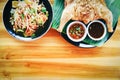 Papaya salad and grilled Chicken with sauce served on plate on the wooden table - Som tum Thai menu Asian food Royalty Free Stock Photo