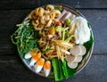 A papaya salad and mixed refreshing vegetables with boiled eggs on the black dish photo taken from the top view. Thailand local fo Royalty Free Stock Photo