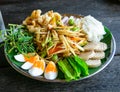 A papaya salad and mixed refreshing vegetables with boiled eggs on the black dish photo taken from the top view. Thailand local Royalty Free Stock Photo