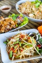 Papaya Salad with Salted Crab and Fermented Fish or Som Tam Poo Pla Ra a famous delicious food in Thailand on wood table Royalty Free Stock Photo