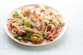 Papaya Salad with Satled Eggs, Pound chilies and garlic then place sliced tomato, eggplant and salted egg. Add fish sauce, lemon,