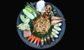 Papaya salad with various side dishes in the tray. Royalty Free Stock Photo