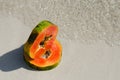 Papaya slice, slice, cut, tropic, fruit, sand water Royalty Free Stock Photo