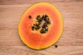 Papaya slice on a wooden cutting board