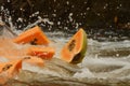 papaya slices diving into a splashy river Royalty Free Stock Photo