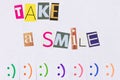 A paper ad with the phrase: Take a Smile and with smile signs.