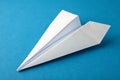 Paper airplane on blue paper background Royalty Free Stock Photo