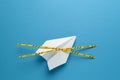 Paper airplane on blue background under quarantine. Cancellation of flights of civil and touristic aviation. Crisis of air travel Royalty Free Stock Photo