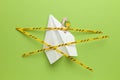 Paper airplane on green background under quarantine. Cancellation of flights of civil and touristic aviation. Crisis of air travel Royalty Free Stock Photo