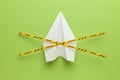 Paper airplane on green background under quarantine. Cancellation of flights of civil and touristic aviation. Crisis of air travel Royalty Free Stock Photo