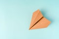 Paper airplane made of craft paper on a light blue background, space for text Royalty Free Stock Photo