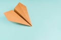 Paper airplane made of craft paper on a light blue background, space for text Royalty Free Stock Photo