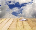 Paper airplane on a wooden platform. Royalty Free Stock Photo