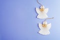 Paper angels on purple background. Christmas concept. Top view, flat lay, copy space