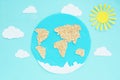 paper application: planet Earth, continents, clouds and the sun on a blue background. Royalty Free Stock Photo