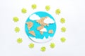 paper application: planet Earth, continents, clouds, sun and green viruses around on a white background. Coronavirus pandemic Royalty Free Stock Photo