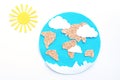 paper application: planet Earth, continents, clouds and the sun on a white background.