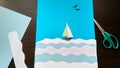 Paper application of a sailboat on the sea and seagulls