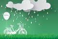 Paper art of bicycle in green garden with rainy season