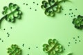 Paper art and craft style four-leaf clover and confetti on green background