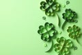 Paper art and craft style four leaf clover on green background