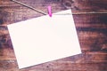 Paper attach to rope with clothes pins on wooden background