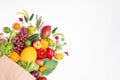 Paper bag with assortment of fresh organic fruits and vegetables on white background, top view Royalty Free Stock Photo