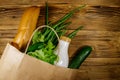 Paper bag with different food on wooden table. Top view. Grocery shopping concept Royalty Free Stock Photo