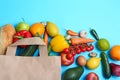 Paper bag with different groceries on light blue background Royalty Free Stock Photo