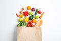 Paper bag with different groceries on white background Royalty Free Stock Photo