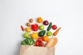 Paper bag with different groceries on white, top view Royalty Free Stock Photo