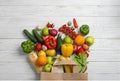 Paper bag with different groceries on white wooden table, flat Royalty Free Stock Photo