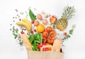 Paper bag of different health food on a white background Royalty Free Stock Photo