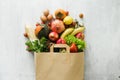 Paper bag of different health food on white wooden background Royalty Free Stock Photo