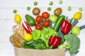 Paper bag of different health food on white wooden background. Top view. Flat lay Royalty Free Stock Photo