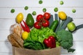 Paper bag of different health food on white wooden background. Top view Royalty Free Stock Photo