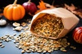 paper bag filled with salted, roasted pumpkin seeds