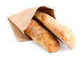 Paper bag with fresh baguettes isolated on white Royalty Free Stock Photo
