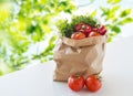 Paper bag with fresh ripe vegetables on table Royalty Free Stock Photo