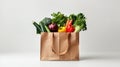 Paper bag full of fresh vegetables on white background. Grocery shopping concept. Generative AI. Royalty Free Stock Photo